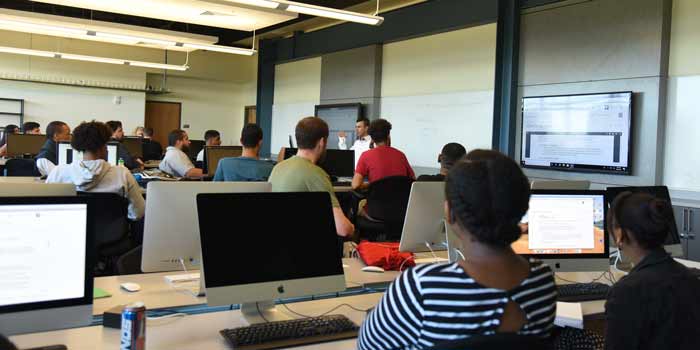 A photo of software engineering degree students at Saint Leo University A photo showing a diverse group of software engineering degree students in a classroom at Saint Leo University on its University Campus