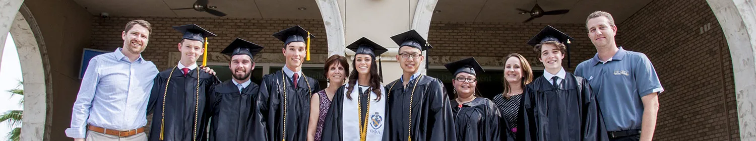 Several students take photos prior to commencement