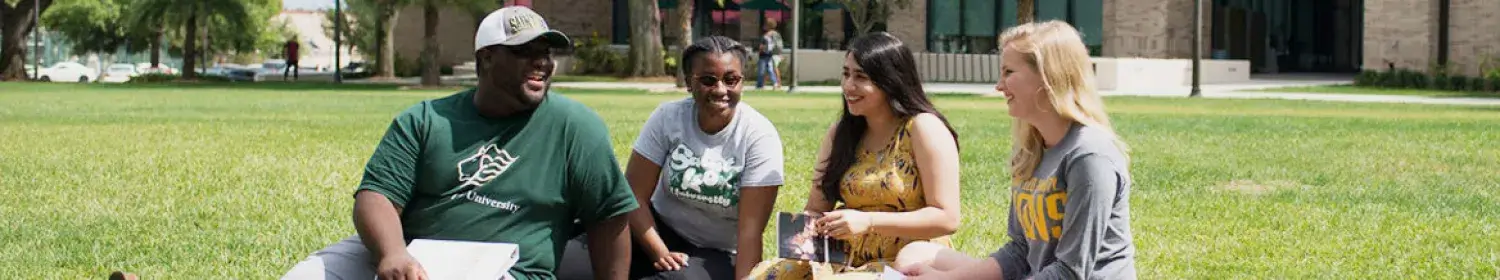 Students sitting on quad banner